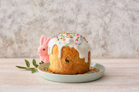 Plate with delicious Easter cake on table