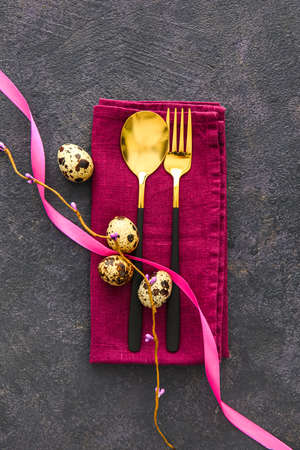Beautiful table setting for Easter celebration on dark backgroundの写真素材
