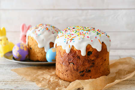Delicious Easter cakes on white wooden background