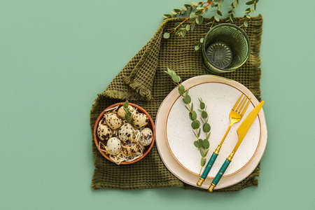 Stylish table setting for Easter celebration on color background
