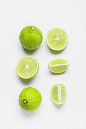 Composition with whole and cut bergamot fruits on white backgroundの写真素材