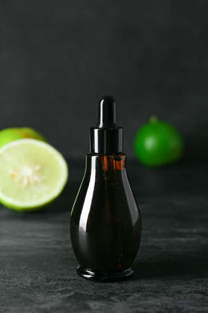 Bottle of bergamot essential oil on dark backgroundの写真素材