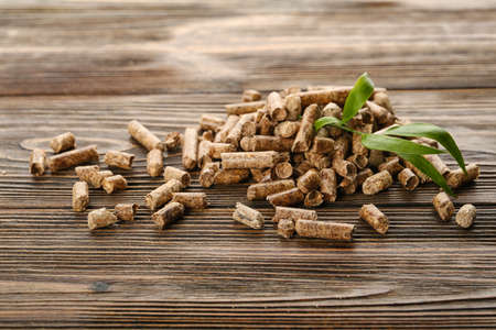 Pile of wood pellets on wooden backgroundの写真素材