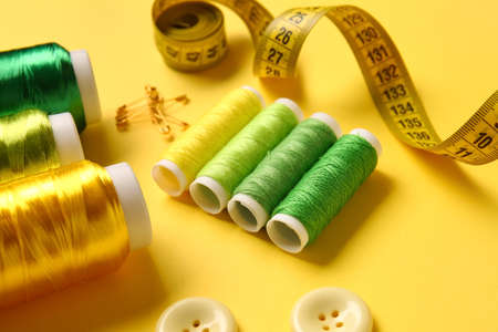 Thread spools on yellow background