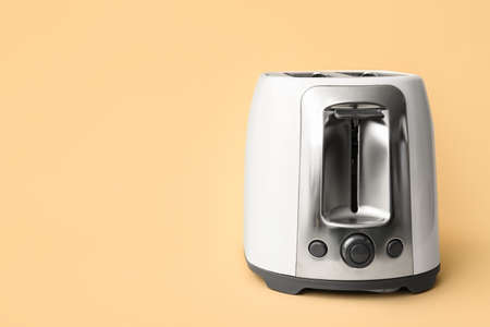 New modern toaster on beige background