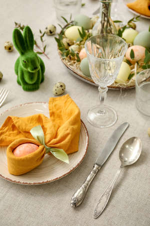 Festive table setting for Easter celebration on light background