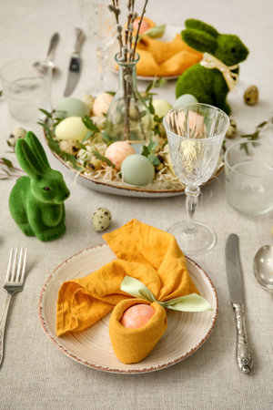 Festive table setting for Easter celebration on light backgroundの写真素材