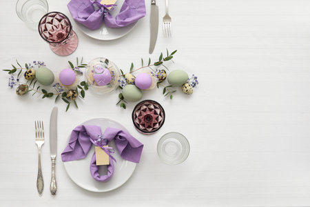 Festive table setting for Easter celebration on light background