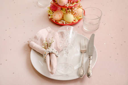 Festive table setting for Easter celebration on light background