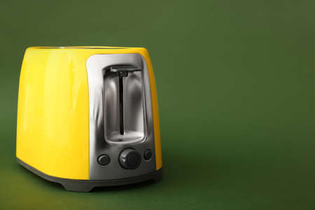 New modern toaster on green backgroundの写真素材