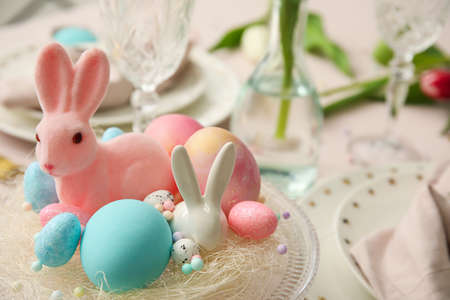 Stand with Easter decor on dining table
