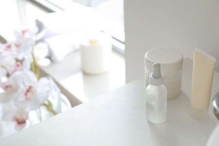Cosmetic products on shelf in bathroom, closeup
