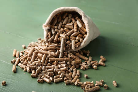 Bag of wood pellets on wooden background