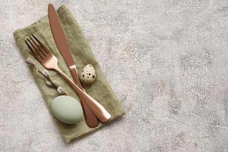 Stylish table setting for Easter celebration on light background, top view