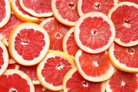 Slices of fresh grapefruit as backgroundの写真素材