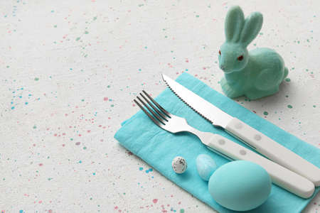 Festive table setting for Easter celebration on light backgroundの写真素材
