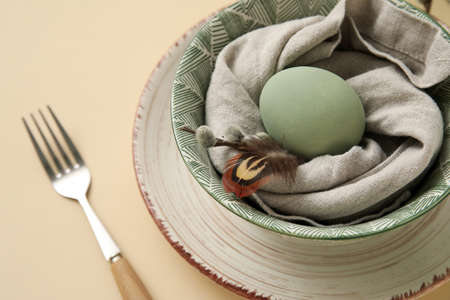 Stylish table setting for Easter celebration with pussy willow branches on beige background, closeup