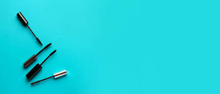 Black mascara on blue background with space for text