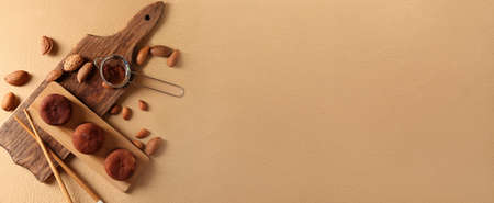 Composition with tasty mochi and almonds on beige background with space for textの写真素材