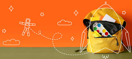 Drawn rocket with backpack and stationery on color backgroundの写真素材
