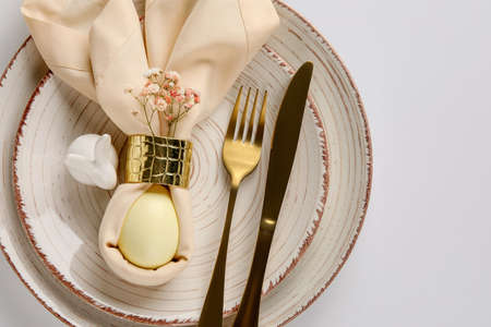 Stylish table setting for Easter celebration with gypsophila flowers on white background