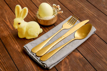 Stylish table setting for Easter celebration on wooden backgroundの写真素材