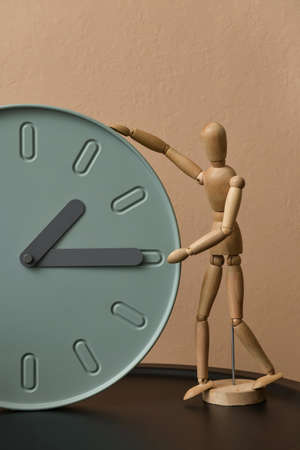 Table with modern clock and mannequin on color background, closeupの写真素材