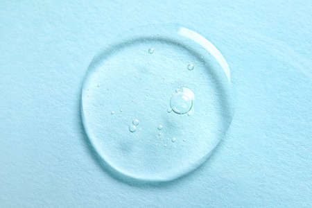 Drop of cosmetic serum on color backgroundの写真素材