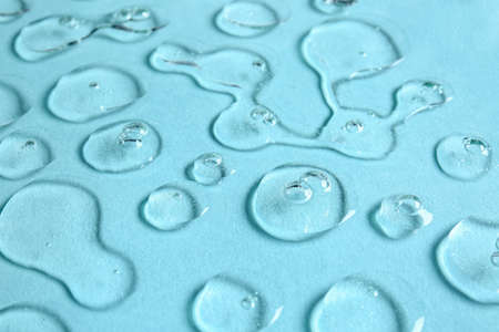 Drops of cosmetic serum on color backgroundの写真素材