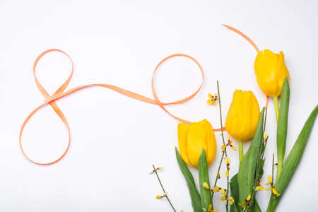 Figure 8 made of ribbon and flowers for International Women's Day celebration on light backgroundの写真素材
