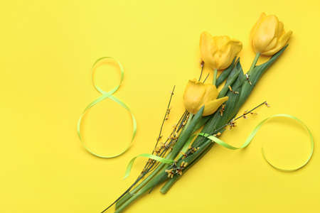 Figure 8 made of ribbon and flowers for International Women's Day celebration on yellow background