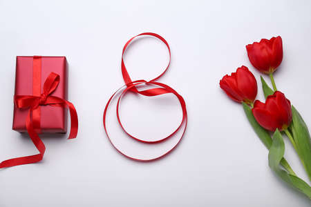 Figure 8 made of ribbon, gift box flowers for International Women's Day celebration on light backgroundの写真素材