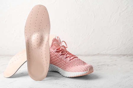 Orthopedic insoles and shoe on light backgroundの写真素材