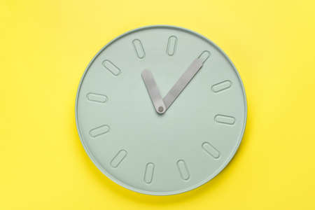 New modern clock on yellow backgroundの写真素材