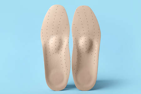Orthopedic insoles on blue backgroundの写真素材