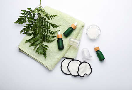 Composition with bottles of essential oil, sea salt, towel and vacuum jars for anti-cellulite massage on white backgroundの写真素材