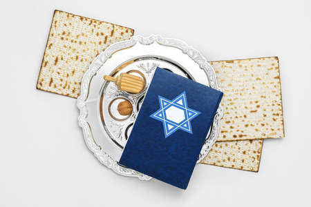 Passover Seder plate, flatbread matza and Torah on light backgroundの写真素材