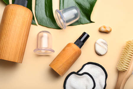 Set of bath supplies with vacuum jars for anti-cellulite massage on color backgroundの写真素材