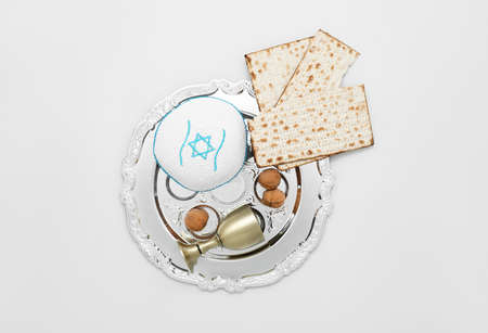 Passover Seder plate, flatbread matza, walnuts and kippah on light backgroundの写真素材