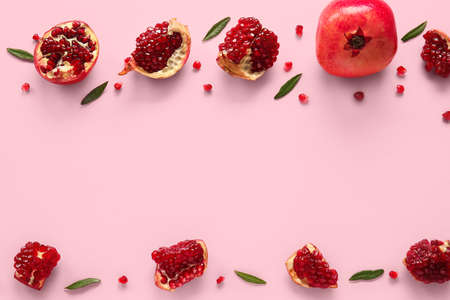 Tasty ripe pomegranate pieces on pink backgroundの写真素材