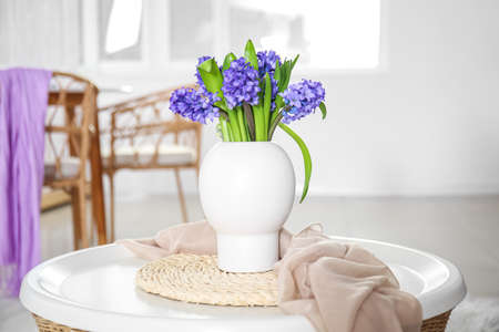 Vase with flowers on the table in the roomの写真素材