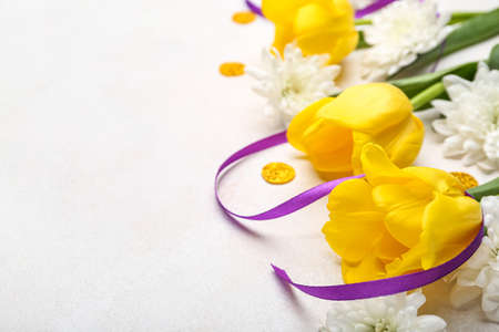 Composition with beautiful flowers for International Women's Day celebration on light background, closeupの写真素材