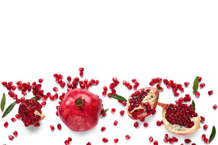 Tasty ripe pomegranate with seeds on white backgroundの写真素材