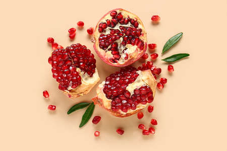 Tasty ripe pomegranate pieces on beige backgroundの写真素材
