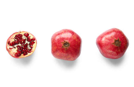 Tasty ripe pomegranates on white background