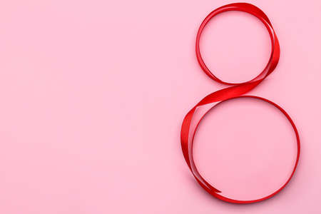 Figure 8 made of ribbon for International Women's Day celebration on pink backgroundの写真素材