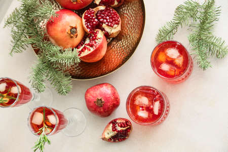 Glasses of tasty pomegranate cocktail on white backgroundの写真素材