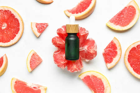 Bottle of grapefruit oil on light backgroundの写真素材