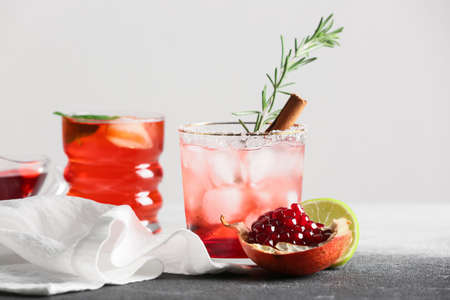 Glasses of tasty pomegranate cocktail on tableの写真素材