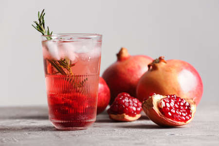 Glass of tasty pomegranate cocktail on tableの写真素材